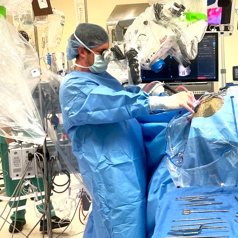 Dr. Evan Winograd, MD performing neurosurgery under the operating microscope